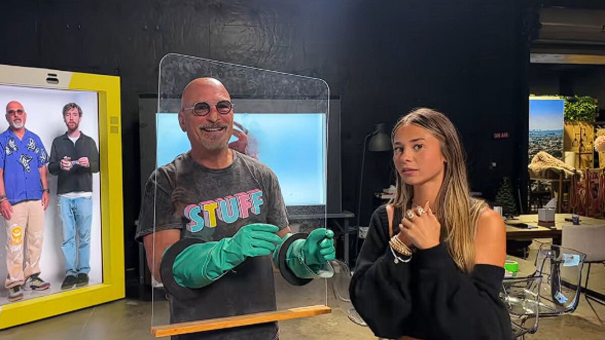 Howie Mandel’s Extreme Germaphobe Moment: Uses Plexiglass Barrier & Long Green Gloves to Shake Hands with Sophie Rain