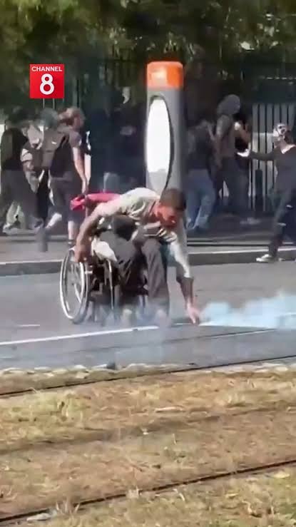 Wheelchair-Bound Protester in France Throws Tear Gas Back at Police During Intense Anti-Government Demonstrations